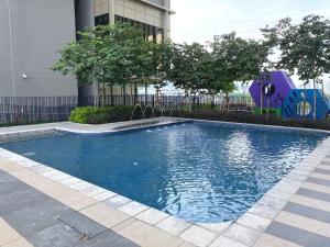 a swimming pool with a playground in front of a building at PAVILION EMBASSY KLCC By ELITE HOST in Kuala Lumpur