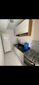 a small kitchen with a sink and a stove at Ap exclusivo 2/4 completo in Feira de Santana