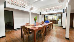 a dining room with a wooden table and chairs at Mango Tree Villa in Unawatuna