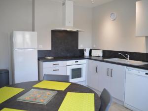 a kitchen with a table with a yellow and white kitchen at Gîte Vouvray sur un Domaine Viticole, Proche Châteaux de la Loire - FR-1-381-167 in Vouvray +17 photos