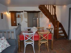 a living room with a table and chairs and a staircase at Gîte Montlouis-sur-Loire, 4 pièces, 5 personnes - FR-1-381-95 in Montlouis-sur-Loire