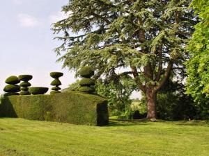 a stone sculpture sitting on top of a grass field at Maison de caractère avec jardin, climatisation et vélos près d'Amboise - FR-1-381-357 in Cangey