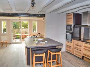 a kitchen with a large island with two bar stools at Gîte Chédigny, 3 pièces, 4 personnes - FR-1-381-480 in Chédigny