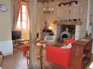 sala de estar con muebles de color rojo y chimenea en Gîte Saint-Senoch, 4 pièces, 7 personnes - FR-1-381-40 en Saint-Senoch