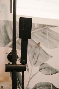 a camera on a tripod in front of a wall at BIG WAVES BOUTIQUE HOTEL SIARGAO in General Luna