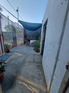 a patio with a table and chairs and a fence at Hostal Brisas del Ometepe in Rivas