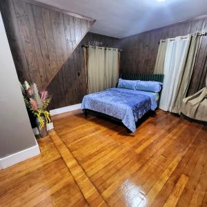 - une chambre avec un lit et du parquet dans l'établissement Majestic Living close to Boston- Family and group friendly, à Stoughton