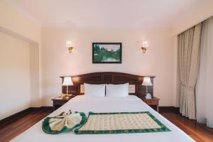 Letto o letti in una camera di Saigon Dalat Hotel