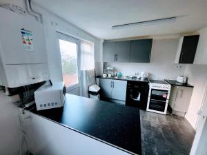 a kitchen with a black counter top in a room at Stay Sleep Rest Heeley, Sheffield in Heeley