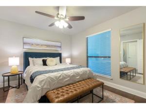 Schlafzimmer mit einem Bett und einem Deckenventilator in der Unterkunft The Flamingo 102 l Pool I 65 Smart TV I Sleeps 5 in Austin