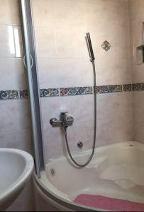 a shower in a bathroom with a tub at Una Maria rooms in Podgorica