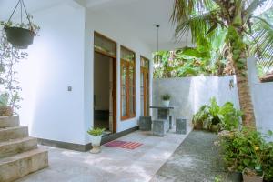 a house with a courtyard with a table and some plants at T20 Mirissa in Mirissa