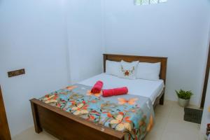 a bedroom with a bed with a butterfly comforter at T20 Mirissa in Mirissa