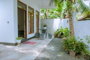 a courtyard with plants and a table in a building at T20 Mirissa in Mirissa +19 photos
