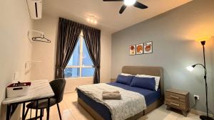 a bedroom with a bed and a desk and a window at NEW Spacious HAUS 4R 8pax WiF-S Pic-Airport in Bayan Lepas