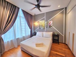 a bedroom with a bed with a ceiling fan at Sky Suites KLCC Kuala Lumpur in Kuala Lumpur