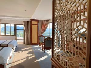 a hotel room with a wall with a wooden partition at Rex hotel An Nhon 