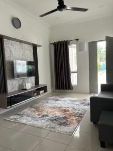 a living room with a television and a couch at Homestay18@KLIA in Sepang