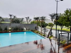 a swimming pool on top of a building at Mkhonto-PR The Millenial Durban, Umhlanga in Durban