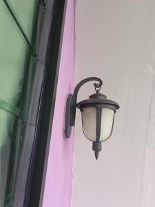 a street light attached to the side of a building at Cameron Highlands Blueberry Earth House in Cameron Highlands