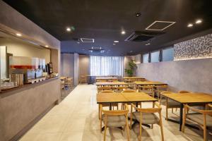a dining room with wooden tables and chairs at 3s HOTEL ATSUGI in Atsugi