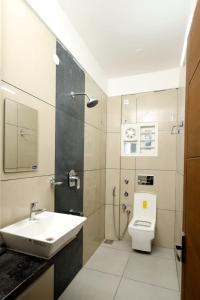 a bathroom with a sink and a toilet at GUEST WEST INN in Cochin