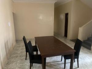 a dining room with a wooden table and chairs at CREPE GAME in Nouakchott