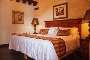 a bedroom with a large bed in a room at Mansion de los Sueños in Pátzcuaro +46 photos