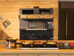 a kitchen with bowls of food on a stove at La'gent Stay Shin Sapporo in Sapporo