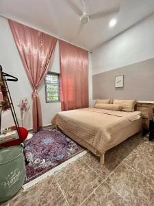 a bedroom with a large bed and a window at Vienna home 2 bedrooms+1 workroom for family in Pantai Cenang