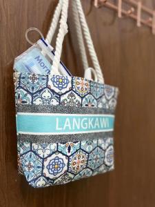 a blue and white purse hanging on a wall at Vienna home 2 bedrooms+1 workroom for family in Pantai Cenang