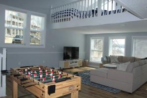 a living room with a foos ball on a table at Grand Glaize Getaway - Hot Tub, Dock, Firepit in Osage Beach