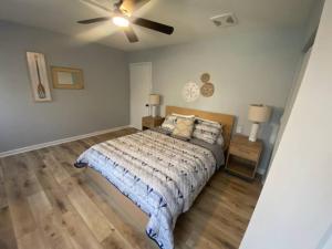 a bedroom with a bed and a ceiling fan at Grand Glaize Getaway - Hot Tub, Dock, Firepit in Osage Beach