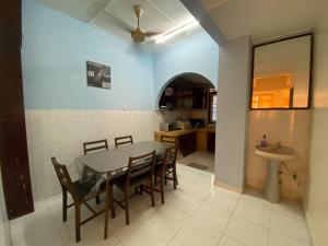 a kitchen and dining room with a table and chairs at JAST 9 HOMESTAY in Port Dickson