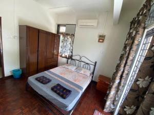 a bedroom with a bed with two pillows on it at JAST 9 HOMESTAY in Port Dickson