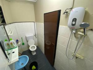 a small bathroom with a toilet and a sink at JAST 9 HOMESTAY in Port Dickson +20 photos