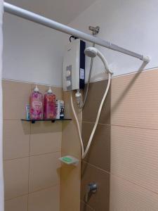 a shower in a bathroom with a shower head at SMDC coolsuites by Maryanne's staycation in Tagaytay