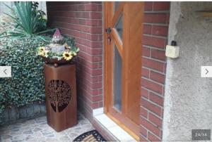 a door to a house with a vase of flowers at Kleines Haus am Wald in Rohrbach