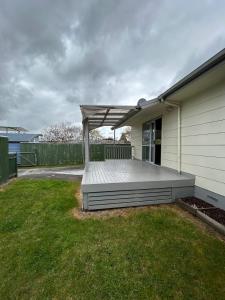 a house with a deck on the side of it at Town Centre Retreat in Taupo