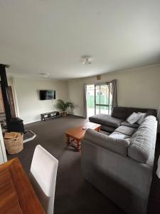 a living room with a couch and a table at Town Centre Retreat in Taupo