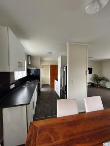 a kitchen with white cabinets and a counter top at Town Centre Retreat in Taupo