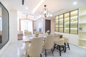 a dining room with a table and chairs at Midtown Premium Phu My Hung in Ho Chi Minh City