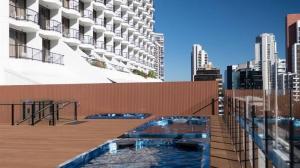 a swimming pool on the roof of a building at Comfy Surfers Paradise Studio with Ocean View in Gold Coast