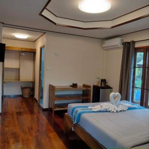 a bedroom with a bed with a heart on it at Walk in homestay in Ko Kood