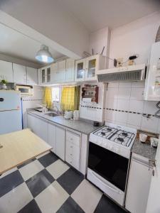 a kitchen with white cabinets and a stove top oven at La Plata Housing I in La Plata