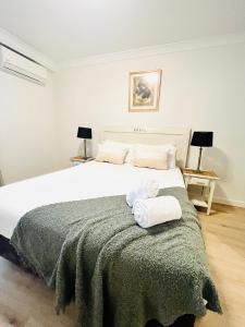 a bedroom with a large bed with two towels on it at 2 Paradise Pool Parking Huge 1br Cbd in Perth