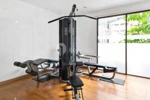 a gym with a treadmill and a simulator at Gratia by Kozystay - 1BR - City View - Kuningan in Jakarta