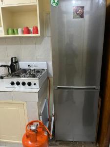 a kitchen with a stainless steel refrigerator next to a stove at Machakos Town Coffee Residencies in Machakos