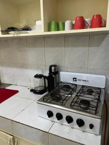 a white stove top oven in a kitchen at Machakos Town Coffee Residencies in Machakos