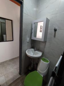a bathroom with a sink and a toilet and a mirror at Apartaestudio Mali's House in Dosquebradas